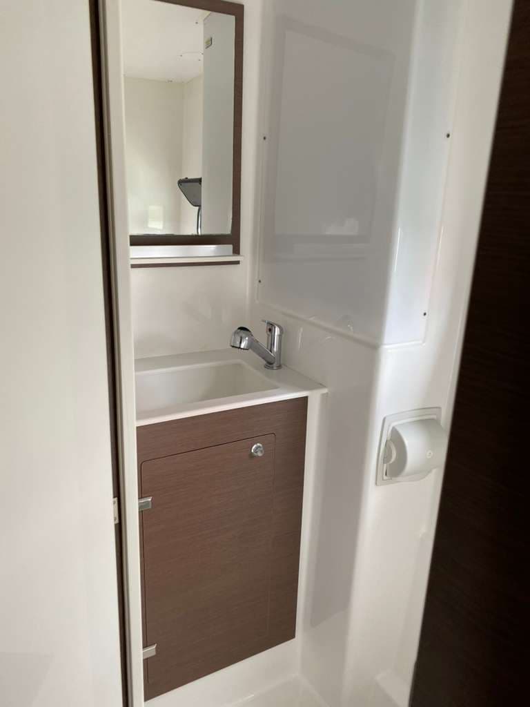 Bali Catspace compact yacht bathroom with sink, mirror, and shower