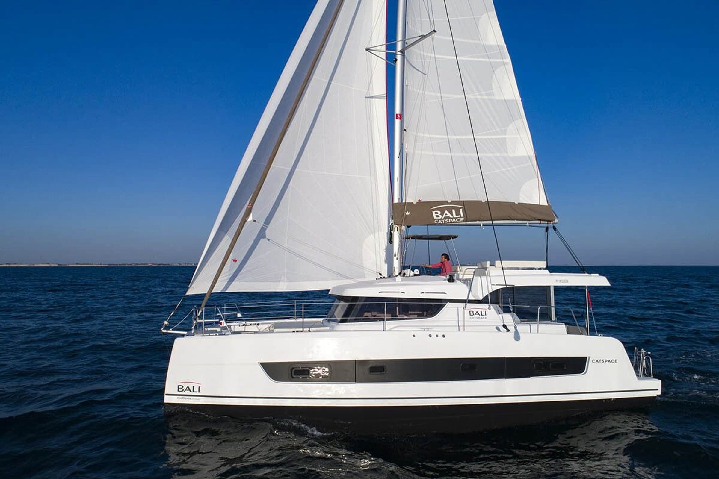 Bali Catspace catamaran under full sail on open water - hero image