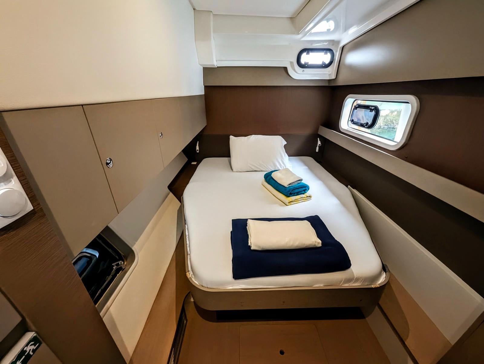 Guest cabin with white linens and blue accent pillows