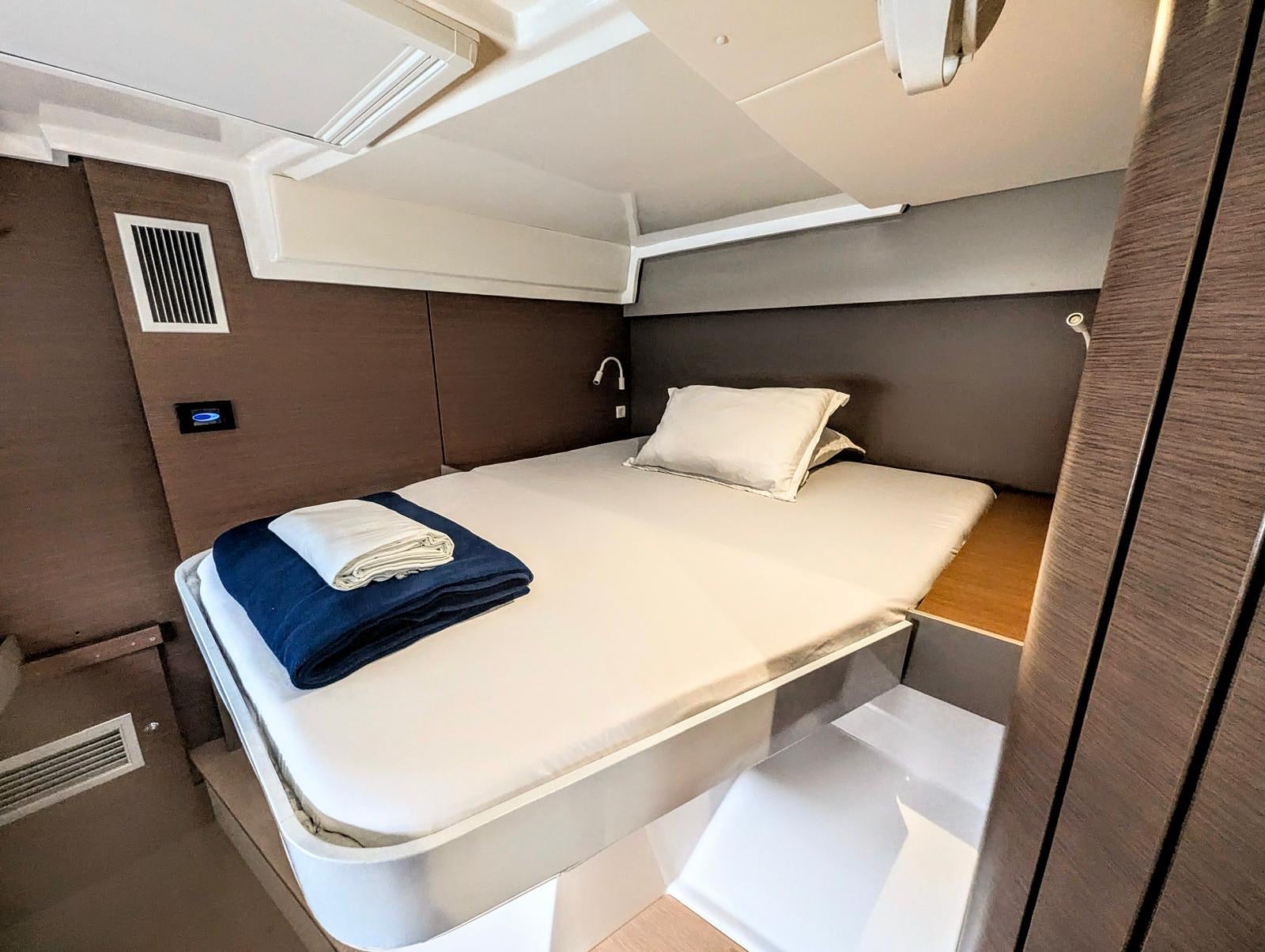 Master cabin with navy runner and AC vent visible