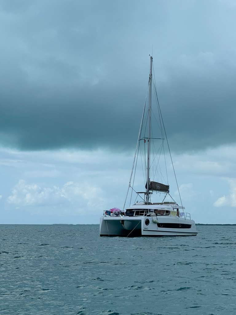 Bali Catspace catamaran at anchor under moody overcast sky