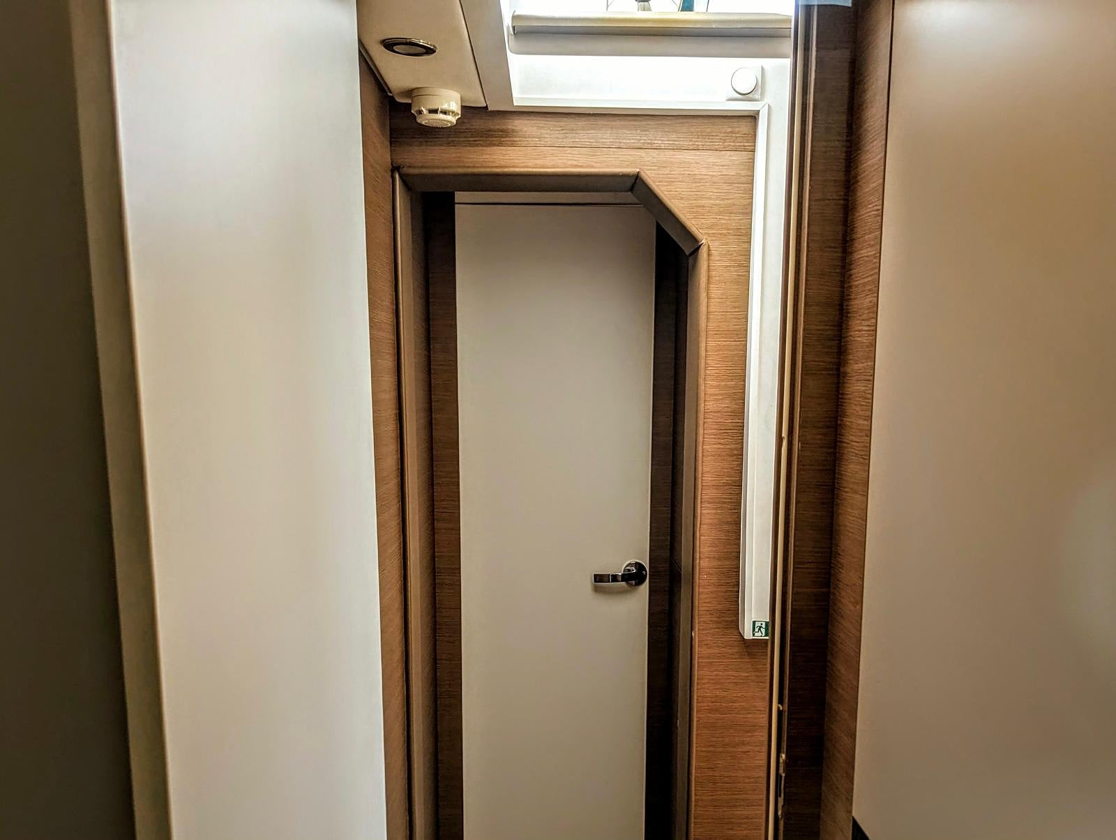 Galley corridor with refrigerator and storage