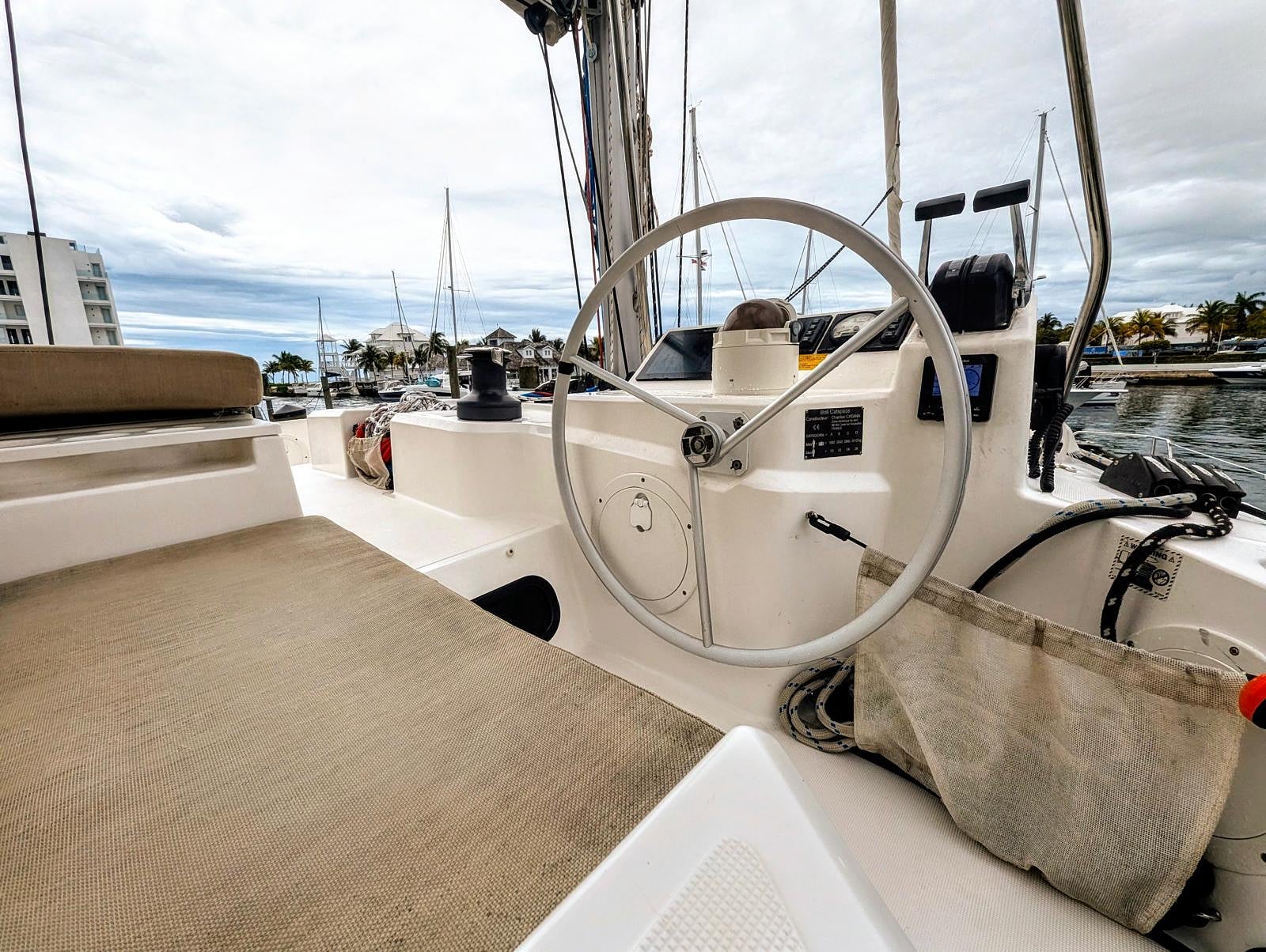 Helm and salon interior with panoramic marina views through windows