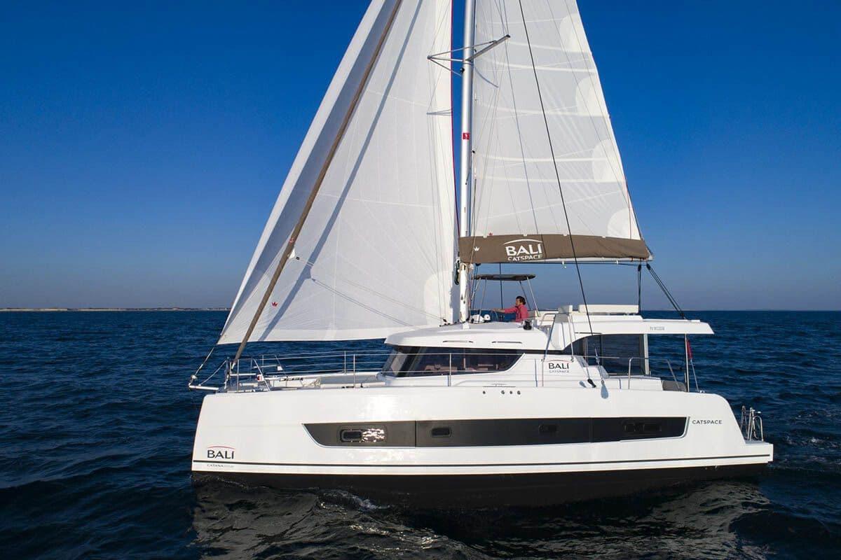 Let's Geaux Bali Catspace under full sail in turquoise water