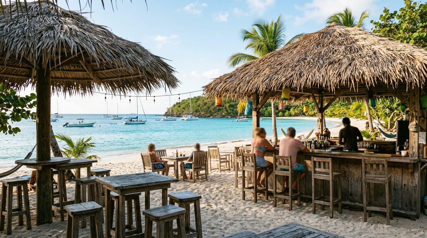 Beach bar scene at Chat N Chill on Stocking Island with palm thatch shade structures and turquoise water beyond