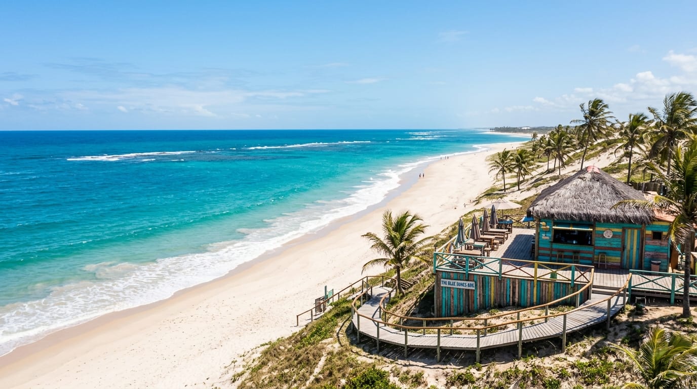 Guana Cay Beach on Great Guana Cay showing white sand stretching into the distance with Nipper's Beach Bar visible on the dune