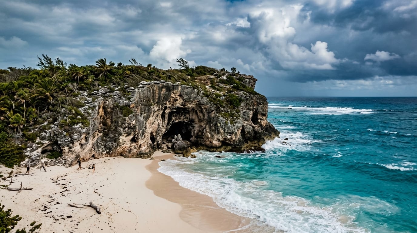 The dramatic limestone bluff at Morgan's Bluff with the cave entrance visible above a crescent of white sand beach